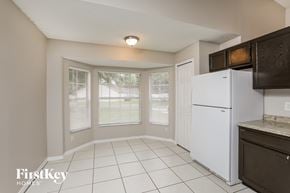 Orlando house for rent - a kitchen with a white refrigerator and a window