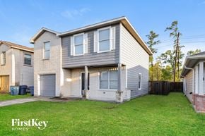 Humble house for rent - A house with a grey and white exterior is shown with the words "FirstKey Homes" on the bottom left.