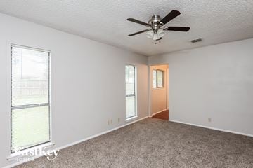 San Antonio house for rent - a living room with carpet and a ceiling fan