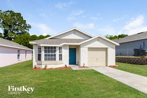 Orlando house for rent - a house with a driveway and a garage door