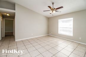 Orlando house for rent - a living room with a ceiling fan and a tiled floor