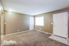 Kansas City house for rent - the living room of an empty house with a white door