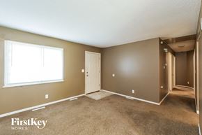 Kansas City house for rent - the living room of an empty house with a large window
