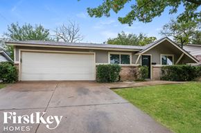 Dallas house for rent - a home with a driveway and a white garage door