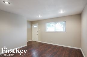 Dallas house for rent - a room with white walls and wooden floors and a window and a door