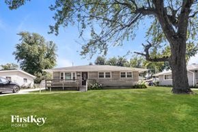 Indianapolis house for rent - a bungalow with a large tree in front of it
