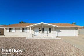 Phoenix house for rent - A house with a brown roof and a gravel driveway in front.