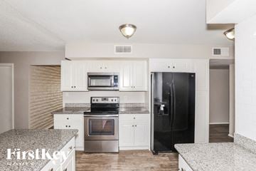 Phoenix house for rent - A kitchen with a black refrigerator and stainless steel appliances.