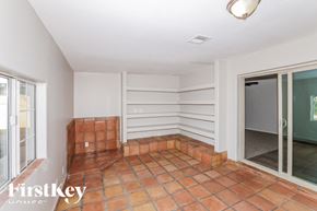 Phoenix house for rent - A room with a tiled floor and a glass door leading outside.