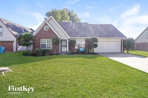 Walls house for rent - A house with a red brick exterior and a white garage door is for sale.