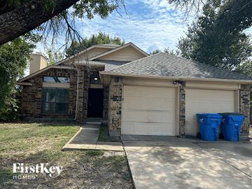 Rowlett house for rent - a house with two trash cans in front of it