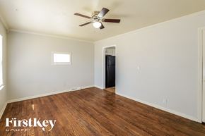 Kansas City house for rent - A room with a wood floor and a ceiling fan.