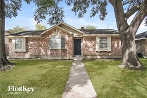 Houston house for rent - a brick house with a sidewalk in front of it