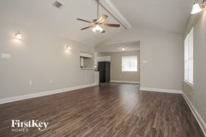 Houston house for rent - the spacious living room with hardwood flooring and a ceiling fan