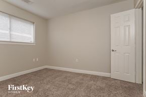 Houston house for rent - the bedroom of a house with a white door and carpet