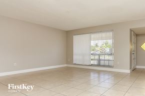 Miramar house for rent - a living room with a large window and a tiled floor