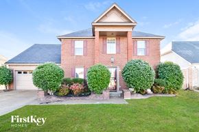 Memphis house for rent - a brick house with a garage and a lawn