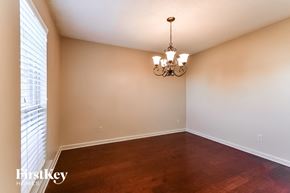 Memphis house for rent - an empty dining room with wood floors and a chandelier