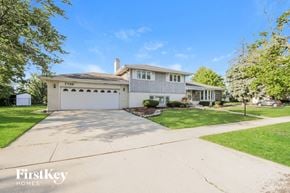 Orland Park house for rent - a white house with a driveway and a white garage door