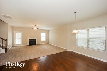 Fairburn house for rent - a living room with a rug and a fireplace