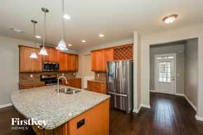 Fairburn house for rent - kitchen with granite countertops and stainless steel appliances and wood flooring