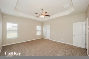 Fairburn house for rent - the master bedroom has a ceiling fan and a carpeted floor