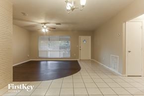 Miramar house for rent - an empty living room with a large window and a hard wood floor