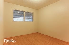 Miramar house for rent - the living room of a house with wood floors and a window