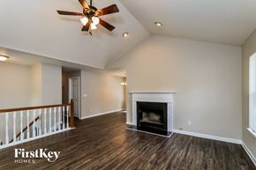 Winston house for rent - a living room with a fireplace and a ceiling fan