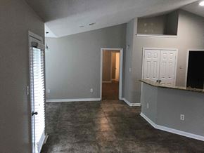 Southaven house for rent - a living room with grey walls and a door to a hallway