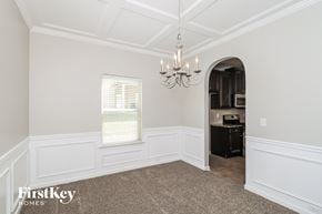 Atlanta house for rent - a dining room with white walls and a chandelier
