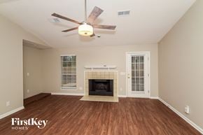 Bessemer house for rent - a living room with a fireplace and a ceiling fan
