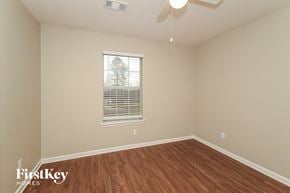 Bessemer house for rent - a bedroom with wood flooring and a window and a ceiling fan