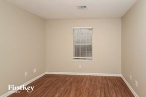 Bessemer house for rent - a spacious room with hardwood floors and a window