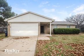 Fort Worth house for rent - a home with a white garage door and a driveway