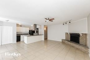 Fort Worth house for rent - a large living room with a fireplace and a kitchen