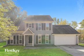 Charlotte house for rent - a with a yard and a white garage door