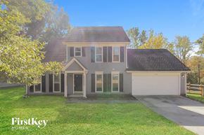 Charlotte house for rent - the front of a house with a lawn and a driveway