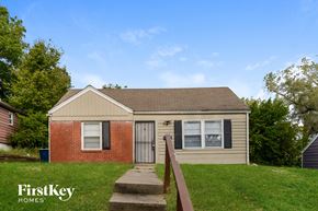 Kansas City house for rent - front view of a small brick house with a yard and stairs