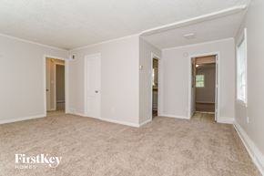 Kansas City house for rent - an empty living room with white walls and carpet