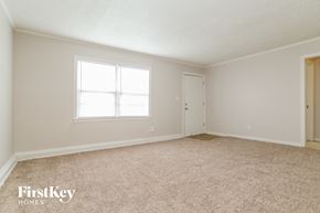 Kansas City house for rent - a bedroom with carpet and a window and a door