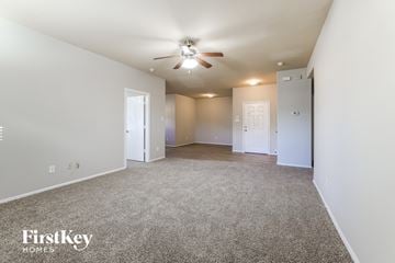 Texas City house for rent - a spacious living room with carpet and a ceiling fan