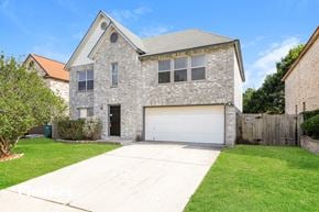 Converse house for rent - A house with a garage and a driveway in front.