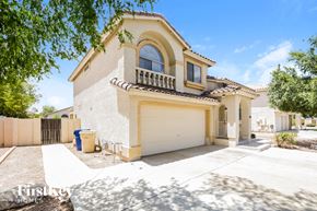 Glendale house for rent - a white and yellow house with a white garage door