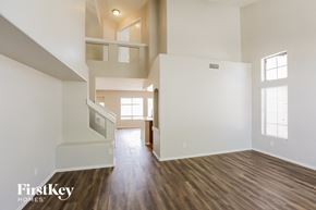 Glendale house for rent - the upstairs living room of an empty house with white walls and wood floors