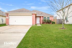 Cypress house for rent - a home with a white garage door and a lawn