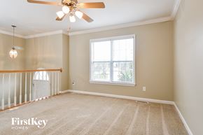 High Point house for rent - A spacious room with a ceiling fan and a window with blinds.