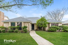 Rowlett house for rent - a brick house with a sidewalk in front of it
