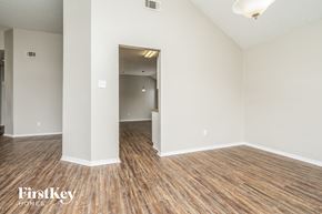 Rowlett house for rent - the living room and dining room of an apartment with wood flooring