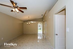 Hialeah house for rent - an empty living room with a ceiling fan